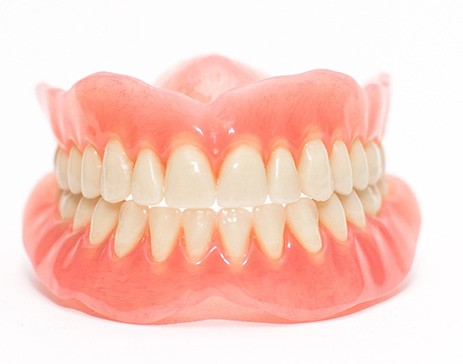Complete set of dentures with white background