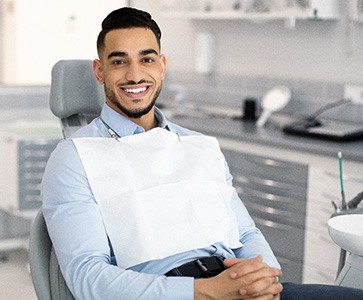 Patient smiling while sitting in treatment chair