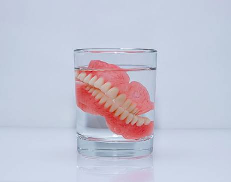 Dentures soak in glass of water?