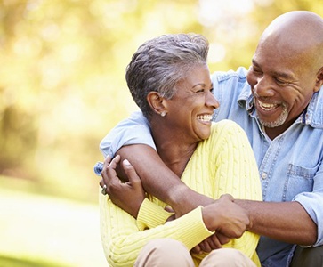 Smiling couple laughing together outside