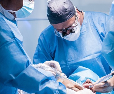 Dentists performing a dental implant surgery