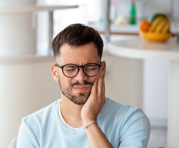 A young man suffering from tooth and mouth pain