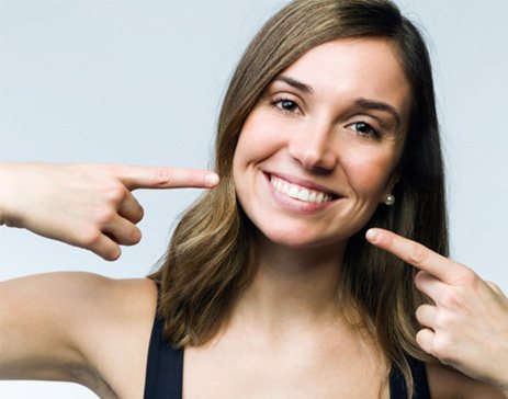 Woman pointing to her teeth