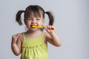 Young girl brushing teeth