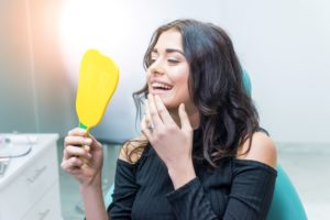 woman looking in dental mirror