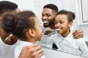 parent and child brushing their teeth