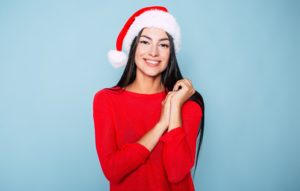 Smiling woman wearing a Santa hat
