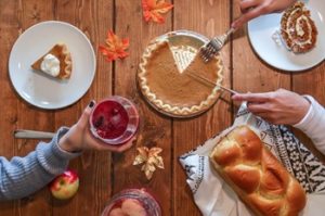 Pumpkin pie and bread on wooden table